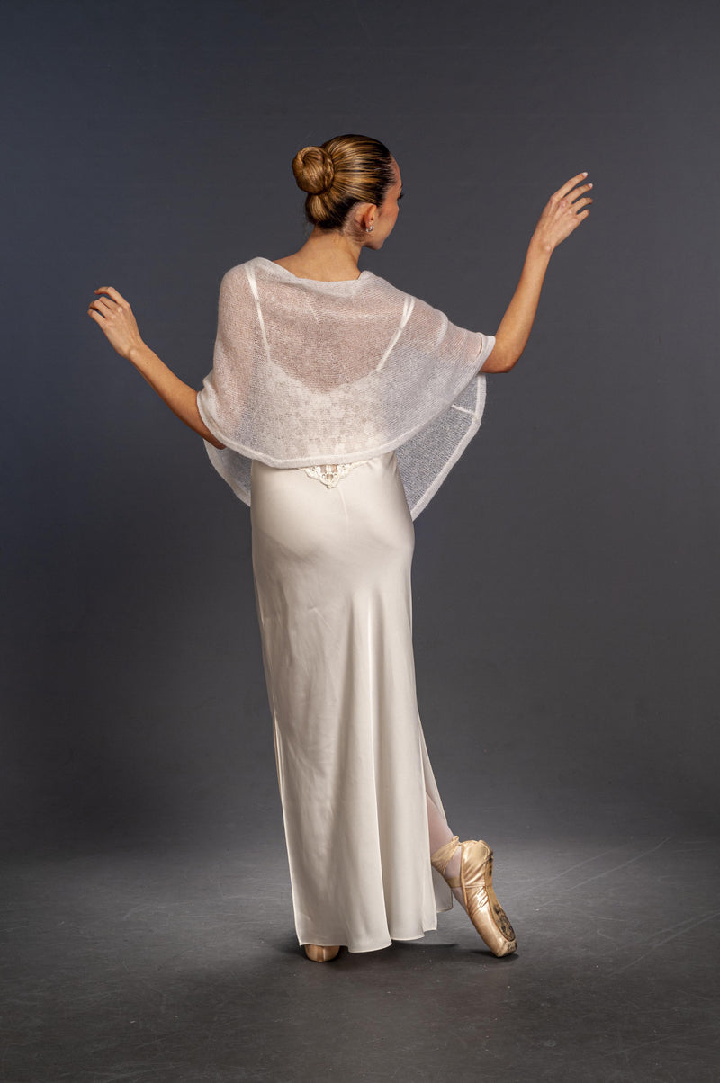 other position view the back of the semi-transparent white bridal poncho